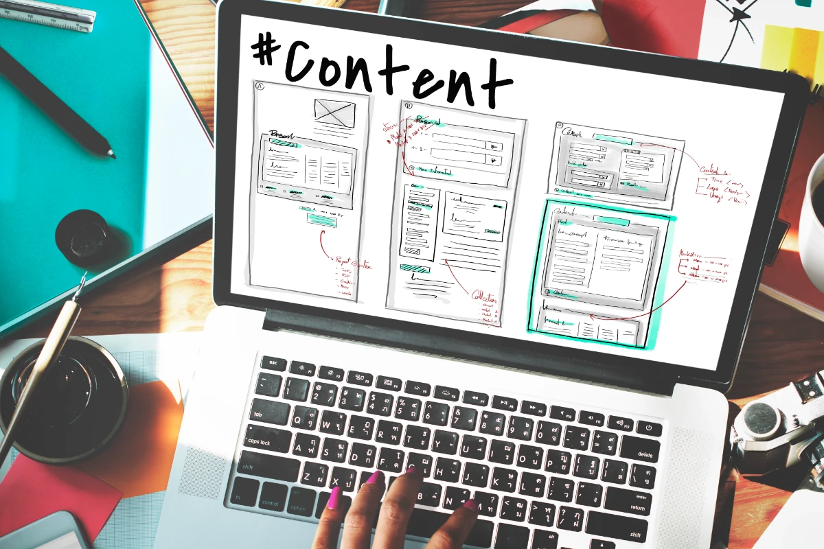 A photo of a laptop displaying a wireframe that shows different ways an original piece of content can be repurposed.